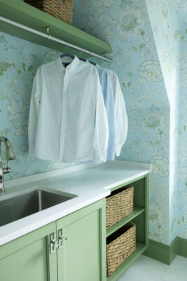 Green Wallpaper and Cabinets in Laundry Room | Twin Construction