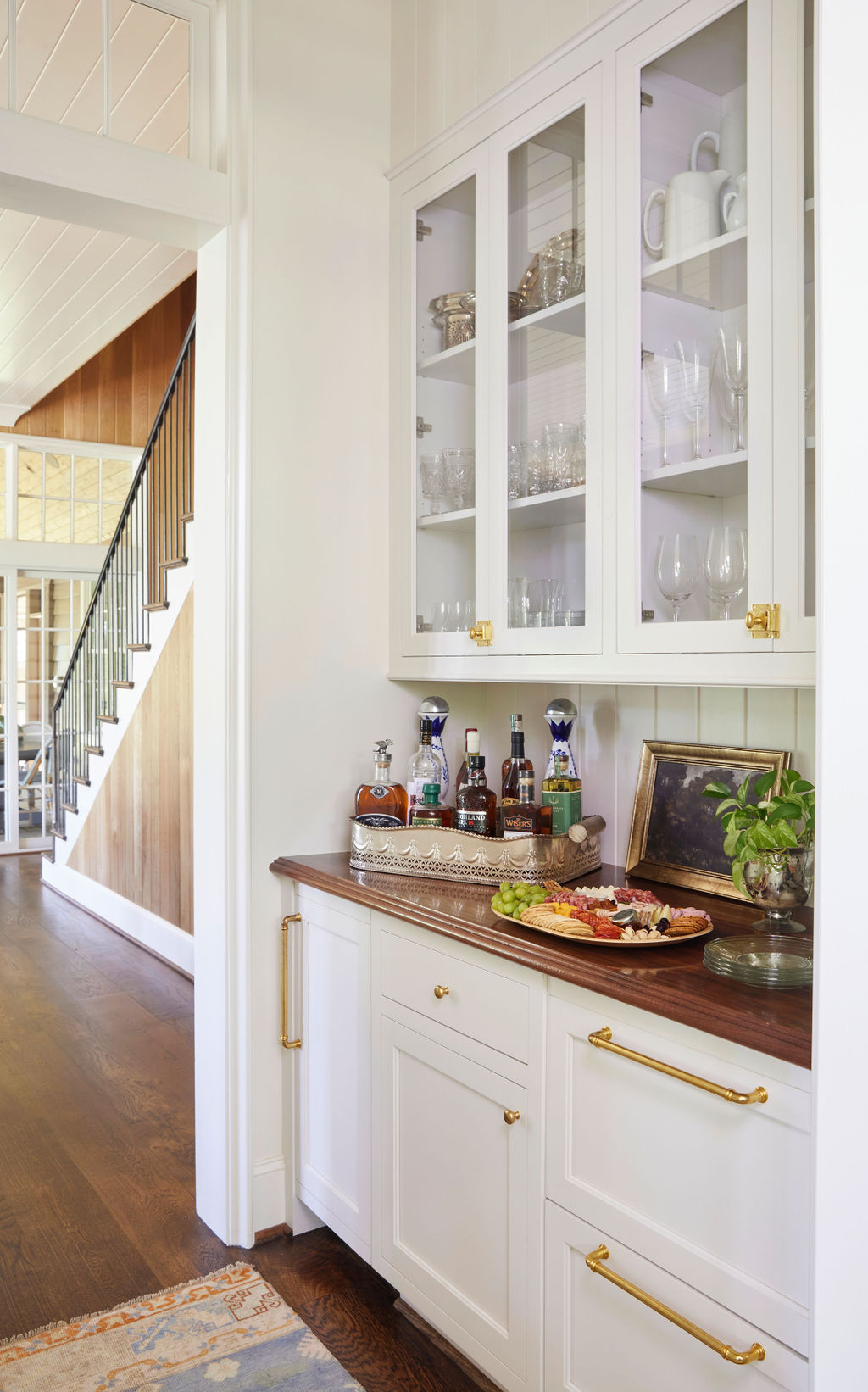 Warm white cabinet and bar nestled in a hallway | Twin Construction